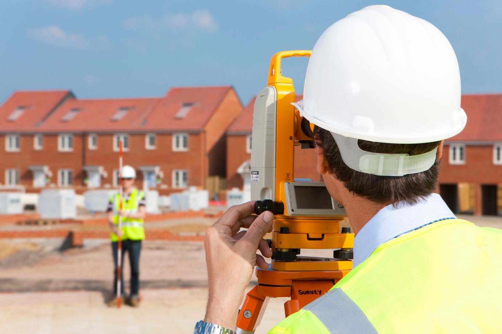 Land surveyor staking a residential development of new rowhouses